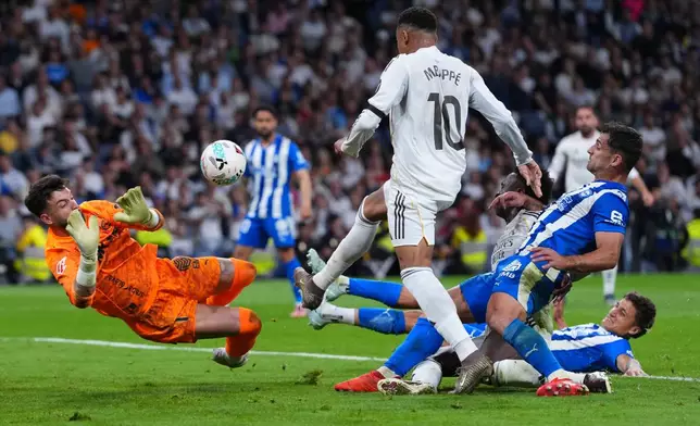 Alaves' goalkeeper Antonio Sivera saves in front oof Real Madrid's Kylian Mbappe during a La Liga soccer match between Real Madrid and Alaves in Madrid, Spain, Tuesday, April 21, 2026. (AP Photo/Manu Fernandez)