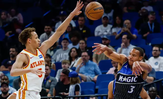 Orlando Magic guard Desmond Bane (3) passes the ball out of the corner as he is defended by Atlanta Hawks guard Dyson Daniels, left, during the first half of an NBA basketball game Wednesday, April 1, 2026, in Orlando, Fla. (AP Photo/Kevin Kolczynski)