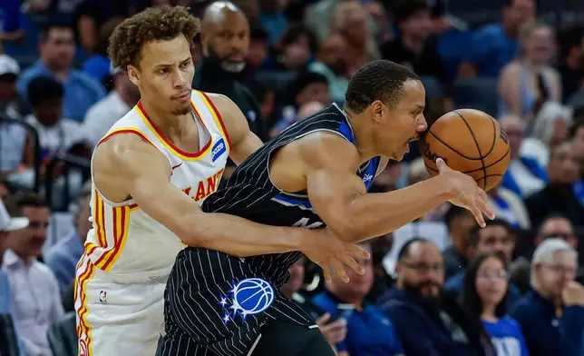 Atlanta Hawks guard Dyson Daniels, knocks the ball out of the hands of Orlando Magic guard Desmond Bane, right, during the first half of an NBA basketball game Wednesday, April 1, 2026, in Orlando, Fla. (AP Photo/Kevin Kolczynski)
