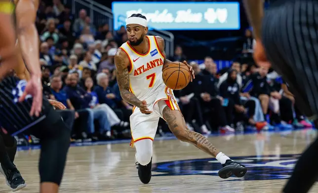 Atlanta Hawks guard Nickeil Alexander-Walker (7) drives down the court against the Orlando Magic during the first half of an NBA basketball game Wednesday, April 1, 2026, in Orlando, Fla. (AP Photo/Kevin Kolczynski)