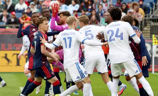 New England Revolution goalkeeper Matt Turner, center, catches the ball on a penalty kick in the first half of an MLS soccer match against CF Montreal, Saturday, April 4, 2026, in Foxborough, Mass. (AP Photo/Mark Stockwell)