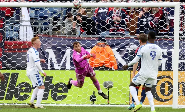 New England Revolution goalkeeper Matt Turner punches the ball away from the net in the first half of an MLS soccer match against CF Montreal, Saturday, April 4, 2026, in Foxborough, Mass. (AP Photo/Mark Stockwell)