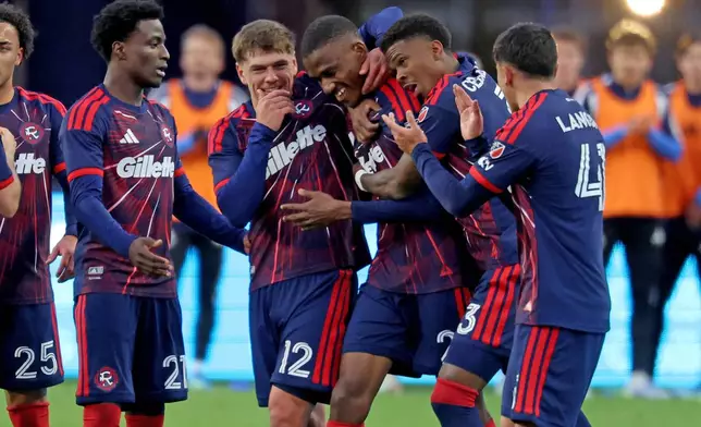 New England Revolution defender Mamadou Fofana, center, is surrounded by teammates after he scored a goal in the second half of an MLS soccer match against CF Montreal, Saturday, April 4, 2026, in Foxborough, Mass. (AP Photo/Mark Stockwell)