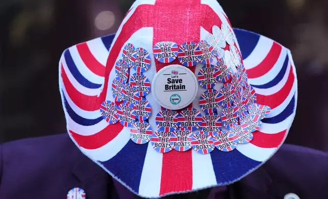 The hat worn by campaigner Joseph Afrane as Reform UK holds a 'national fuel tax protest' to protest against the Government's plans to raise fuel duty for the first time in 15 years, in London, Monday, April 27, 2026. (AP Photo/Kirsty Wigglesworth)