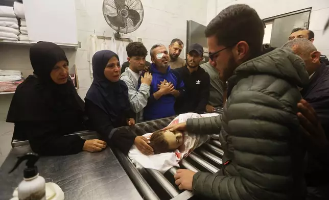 Palestinians mourn over Naya Al-Tanani, killed in an Israeli strike, at Al-Shifa Hospital in Gaza City, Saturday, April 25, 2026. (AP Photo/Yousef Alzanoun)