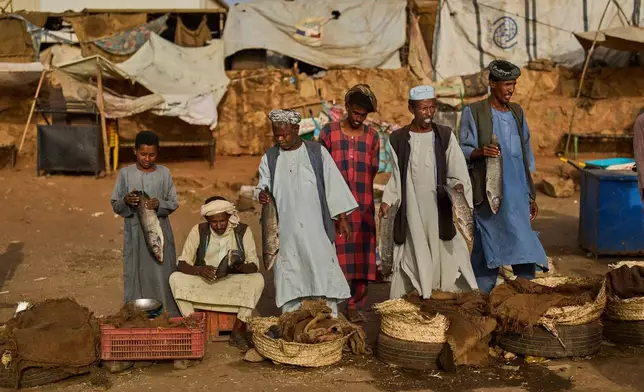 Fish vendors wait for customers at a market in Omdurman, on the outskirts of Khartoum, Sudan, Sunday, April 26, 2026. (AP Photo/Bernat Armangue)
