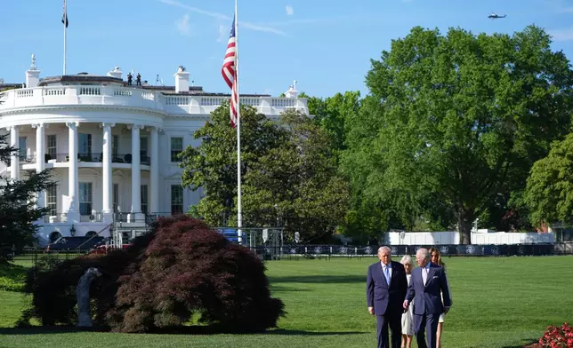 President Donald Trump and first lady Melania Trump along with Britain's King Charles III and Queen Camilla walk on the South Lawn to visit the White House garden and bee hive at the White House, Monday, April 27, 2026, in Washington. (AP Photo/Alex Brandon, Pool)