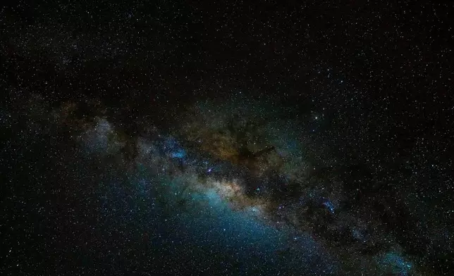 The Milky Way stretches across the night sky as seen from the Atacama Desert, Chile, Wednesday, April 15, 2026. (AP Photo/Esteban Felix)