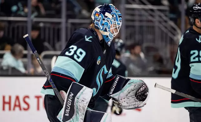 Seattle Kraken goaltender Nikke Kokko makes a save during the second period of an NHL hockey game against the Calgary Flames, Saturday, April 11, 2026, in Seattle. (AP Photo/Maddy Grassy)