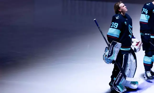 Seattle Kraken goaltender Nikke Kokko (39) stands during the National Anthem before an NHL hockey game against the Calgary Flames, Saturday, April 11, 2026, in Seattle. (AP Photo/Maddy Grassy)
