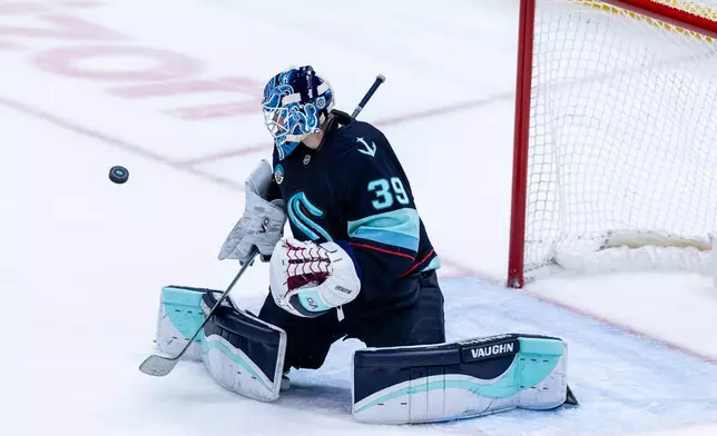Seattle Kraken goaltender Nikke Kokko makes a save during the first period of an NHL hockey game against the Calgary Flames, Saturday, April 11, 2026, in Seattle. (AP Photo/Maddy Grassy)