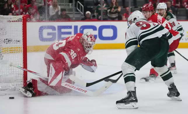 Detroit Red Wings goaltender Cam Talbot (39) stops a Minnesota Wild left wing Kirill Kaprizov (97) shot in the third period of an NHL hockey game Sunday, April 5, 2026, in Detroit. (AP Photo/Paul Sancya)