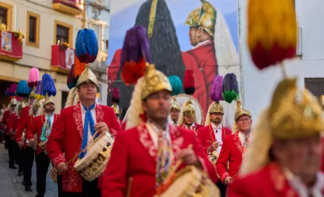 Members of the "White-tail Jews," march while playing drums alongside the Nuestro Padre Jesus del Huerto y San Diego brotherhood during a Holy Week procession in Baena, southern Spain, Wednesday, April 1, 2026. (AP Photo/Manu Fernandez)