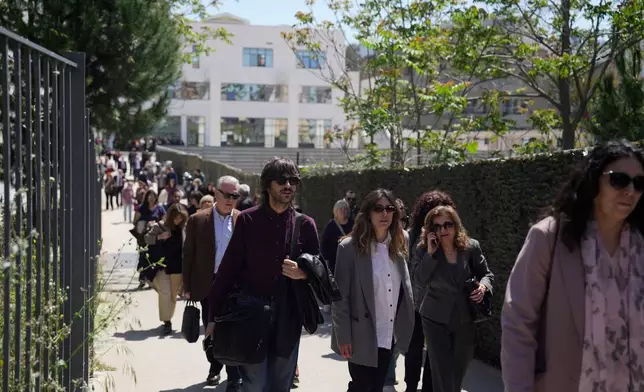 People leave a courthouse after a gunman opened fire leaving several people wounded in Athens, Tuesday, April 28, 2026. (AP Photo/Petros Giannakouris)
