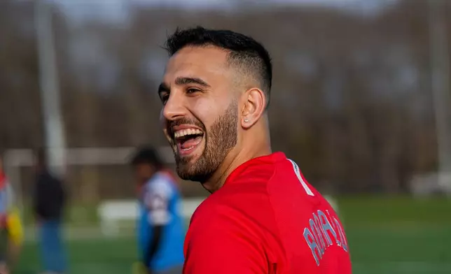 Tehran native and Stony Brook University graduate student Arad Ershad laughs while playing soccer at Stony Brook University in Stony Brook, N.Y., Friday, April 3, 2026. (AP Photo/Ryan Murphy)