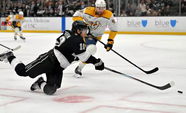 Nashville Predators defenseman Nicolas Hague (41) looks on as Los Angeles Kings left wing Artemi Panarin (10) takes a shot on goal during the second period of an NHL hockey game Thursday, April 2, 2026, in Los Angeles. (AP Photo/Jayne Kamin-Oncea)