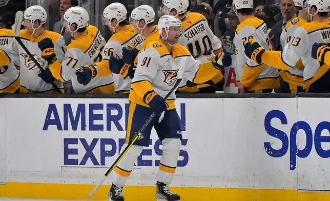 Nashville Predators center Steven Stamkos (91) is congratulated at the bench after scoring a goal during the second period of an NHL hockey game, against the Los Angeles Kings, Thursday, April 2, 2026, in Los Angeles. (AP Photo/Jayne Kamin-Oncea)