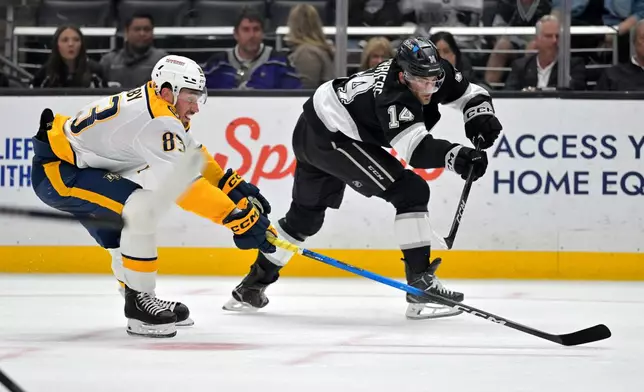 Nashville Predators defenseman Adam Wilsby, left, and Los Angeles Kings right wing Alex Laferriere battle for the puck during the second period of an NHL hockey game Thursday, April 2, 2026, in Los Angeles. (AP Photo/Jayne Kamin-Oncea)