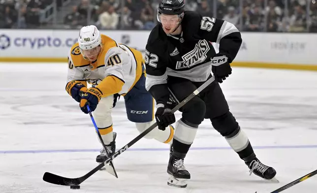Los Angeles Kings right wing Taylor Ward (52) handles the puck away from Nashville Predators center Fedor Svechkov (40) during the second period of an NHL hockey game Thursday, April 2, 2026, in Los Angeles. (AP Photo/Jayne Kamin-Oncea)
