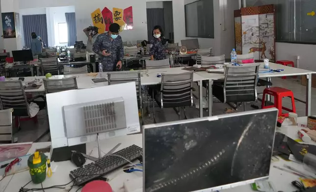 Thai soldiers inspect a work station at the scam compound in O'Smach, Cambodia, Tuesday, April 7, 2026. (AP Photo/Sakchai Lalit)