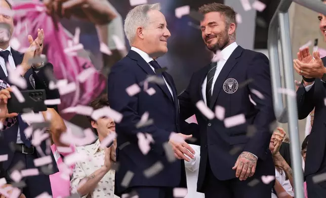 Inter Miami CF managing owner Jorge Mas, left, and co-owner David Beckham, right, stand together during a ribbon cutting ceremony before Inter Miami's first MLS soccer match in Nu Stadium against Austin FC , Saturday, April 4, 2026, in Miami. (AP Photo/Lynne Sladky)