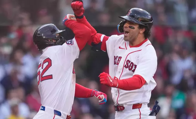 Boston Red Sox's Marcelo Mayer, right, celebrates with Wilyer Abreu (52) after his two-run home run against the San Diego Padres during the sixth inning of the home-opener baseball game at Fenway Park, Friday, April 3, 2026, in Boston. (AP Photo/Charles Krupa)