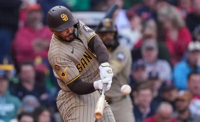 San Diego Padres' Luis Campusano hits an RBI double during the fifth inning of a home-opener baseball game against the Boston Red Sox at Fenway Park, Friday, April 3, 2026, in Boston. (AP Photo/Charles Krupa)
