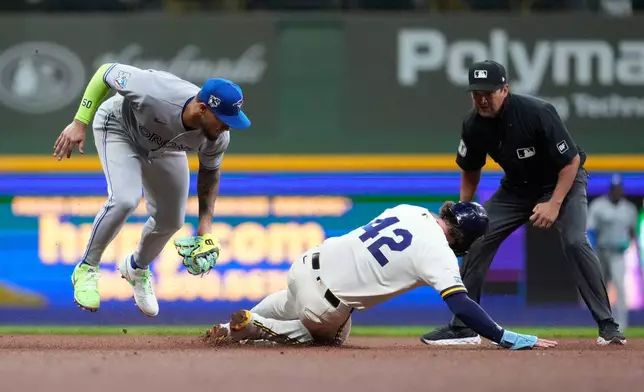 Toronto Blue Jays' Lenyn Sosa, left, tags out Milwaukee Brewers' Brice Turang at second base during the sixth inning of a baseball game Wednesday, April 15, 2026, in Milwaukee. (AP Photo/Aaron Gash)