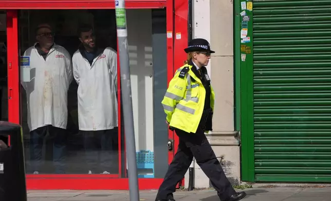 A Police officer patrols the high street after two people were stabbed in Golders Green neighbourhood, that has a large Jewish community, in London, Wednesday, April 29, 2026.(AP Photo/Kin Cheung)