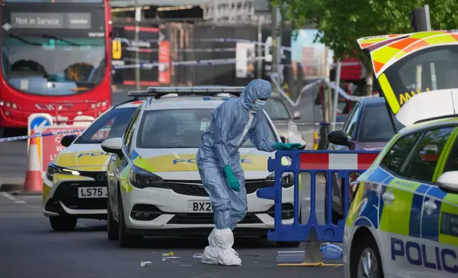 Forensic officers search the area after two people were stabbed in Golders Green neighborhood, that has a large Jewish community, in London, Wednesday, April 29, 2026.(AP Photo/Kin Cheung)