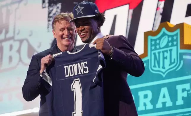Ohio State defensive back Caleb Downs poses with NFL Commissioner Roger Goodell after being chosen by the Dallas Cowboys with the 11th overall pick during the first round of the NFL football draft, Thursday, April 23, 2026, in Pittsburgh. (AP Photo/Gene J. Puskar)
