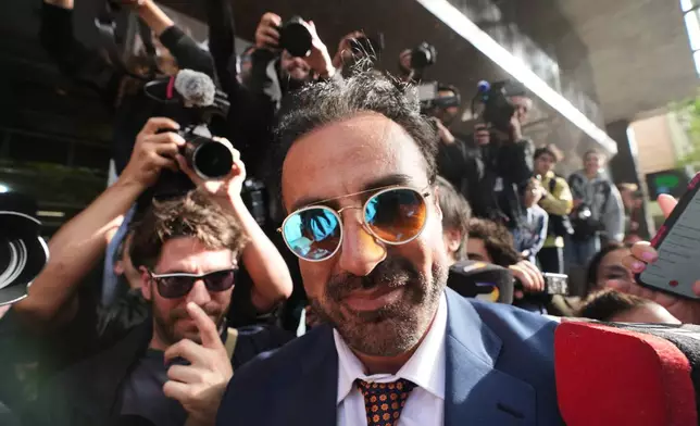 Physician Leopoldo Luque arrives to court to attend the first day of his trial with the medical team that treated the late soccer star Diego Maradona, to face charges of alleged homicide by negligence in San Isidro, Argentina, Tuesday, April 14, 2026. (AP Photo/Rodrigo Abd)