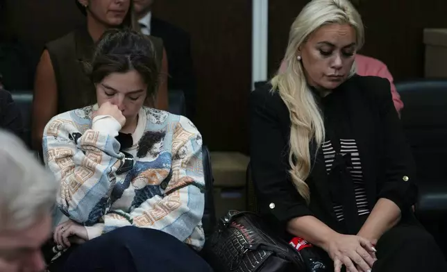 Dalma Maradona, left, the daughter of late Diego Maradona, and Veronica Ojeda, former partner of the late soccer star, attend the first day of the trial of his medical team for alleged homicide by negligence in San Isidro, Argentina, Tuesday, April 14, 2026. (AP Photo/Rodrigo Abd)
