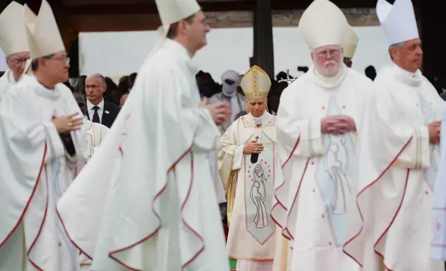 Pope Leo XIV arrives in procession with cardinals and bishops to celebrate Mass at Yaounde Ville Airport, Cameroon, Saturday, April 18, 2026 on the sixth day of his 11-day pastoral visit to Africa. (AP Photo/Andrew Medichini)