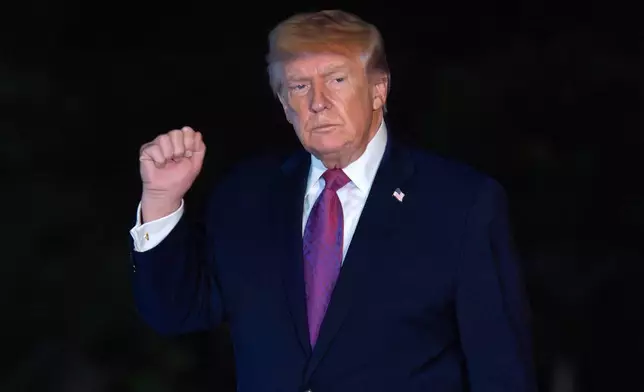 President Donald Trump waves to reporters as he walks on the South Lawn upon his arrival to the White House, Friday, April 17, 2026, in Washington. (AP Photo/Jose Luis Magana)
