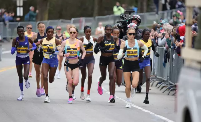 Jess McClain, right, runs in the lead pack on the Boston Marathon course in Newton, Mass., on Monday, April 20, 2026. (AP Photo/Jennifer McDermott)