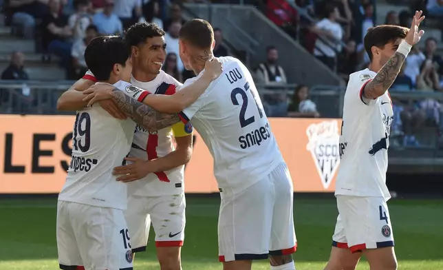 PSG's Lee Kang-in, left, celebrates with Achraf Hakimi and Lucas Hernandez after scoring during the French League One soccer match between Angers and Paris Saint-Germain in Angers, western France, Saturday, April 25, 2026. (AP Photo/Mathieu Pattier)