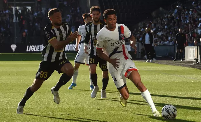 PSG's Senny Mayulu, right, challenges for the ball with Angers' Haris Belkebla, left, during the French League One soccer match between Angers and Paris Saint-Germain in Angers, western France, Saturday, April 25, 2026. (AP Photo/Mathieu Pattier)