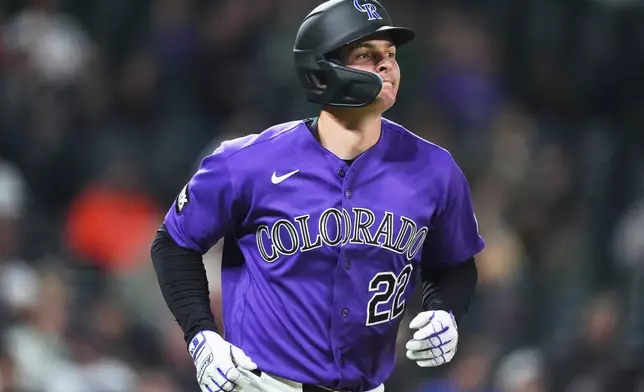 Colorado Rockies' Mickey Moniak heads up the first-base line after hitting a two-run home run off Houston Astros relief pitcher Kai-Wei Teng in the seventh inning of a baseball game Tuesday, April 7, 2026, in Denver. (AP Photo/David Zalubowski)
