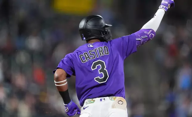 Colorado Rockies' Willi Castro gestures to the bullpen as he circles the bases after hitting a two-run home run off Houston Astros starting pitcher Mike Burrows in the fourth inning of a baseball game Tuesday, April 7, 2026, in Denver. (AP Photo/David Zalubowski)