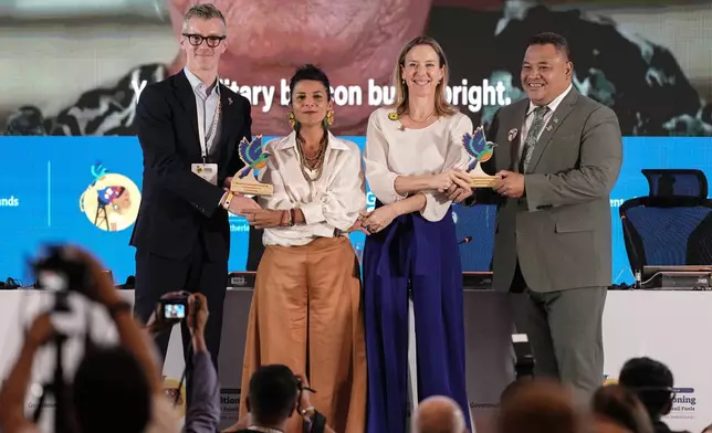 Philip Nugent, director general for EU, international and marine affairs, from left, Colombia's Environmental Minister Irene Vélez Torres, Stientje van Veldhoven, minister of climate policy and green growth of the Netherlands, and Maina Talia, minister of home affairs, climate change and environment of Tuvalu, pose at the end of a conference aimed at transitioning away from fossil fuels Wednesday, April 29, 2026, in Santa Marta, Colombia. (AP Photo/Ivan Valencia)
