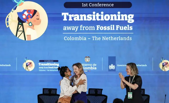 Colombia's Environmental Minister Irene Vélez Torres, left, embraces Stientje van Veldhoven, minister of climate policy and green growth of the Netherlands, at the end of a conference aimed at transitioning away from fossil fuels Wednesday, April 29, 2026, in Santa Marta, Colombia. (AP Photo/Ivan Valencia)