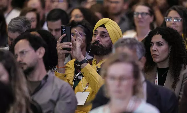 Attendees listen to the closing of conference aimed at transitioning away from fossil fuels Wednesday, April 29, 2026, in Santa Marta, Colombia. (AP Photo/Ivan Valencia)