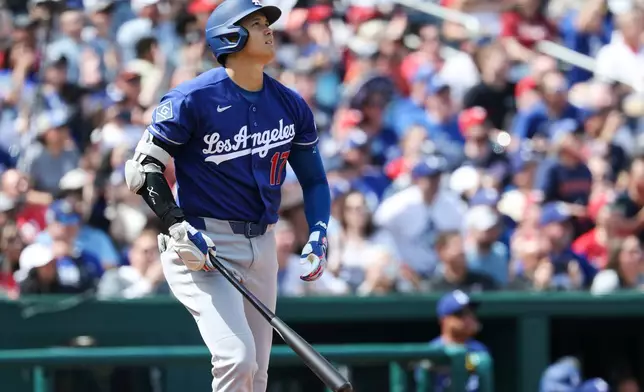 Los Angeles Dodgers' Shohei Ohtani (17) watches his three-run home run during the third inning of an baseball game against the Washington Nationals, Friday, April 3, 2026, in Washington. (AP Photo/Terrance Williams)