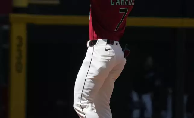Arizona Diamondbacks' Corbin Carroll reacts after hitting a solo home run against the Detroit Tigers in the first inning of a baseball game, Wednesday, April 1, 2026, in Phoenix. (AP Photo/Rick Scuteri)