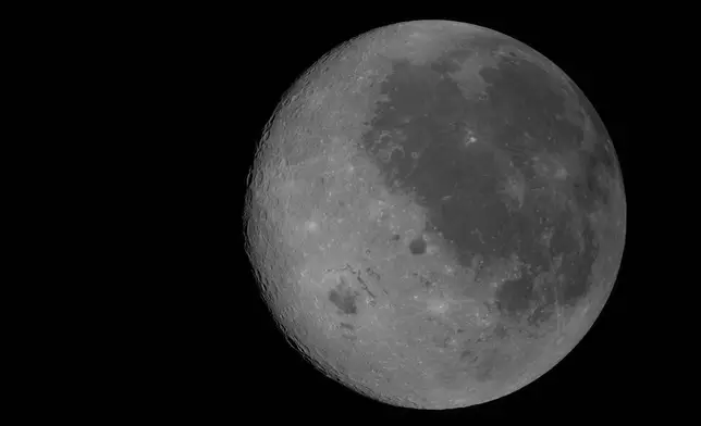 This image provided by NASA Monday, April 6, 2026, shows the Moon, the near side (the hemisphere we see from Earth) visible at the right side of the disk, identifiable by the dark splotches. At lower left is Orientale basin, a nearly 600-mile-wide crater that straddles the Moon’s near and far sides. Everything to the left of the crater is the far side. (NASA via AP)