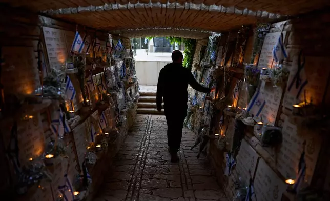 A man visits Mount Herzl military cemetery in Jerusalem on the eve of Israel's annual Memorial Day for the fallen soldiers, Monday, April 20, 2026. (AP Photo/Ohad Zwigenberg)