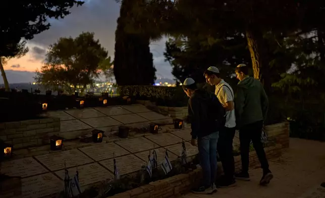 People visit the Mount Herzl military cemetery in Jerusalem on the eve of Israel's annual Memorial Day for the fallen soldiers, Monday, April 20, 2026. (AP Photo/Ohad Zwigenberg)