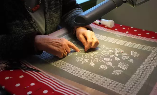 A woman demonstrates lacemaking in the Beguinage of Lier, Belgium, during an open day on Saturday, March 28, 2026. (AP Photo/Virginia Mayo)
