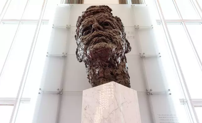 An eight foot tall bronze bust of President John F. Kennedy is seen in the Grand Foyer of the John F. Kennedy Center for the Performing Arts during a media tour to show building damage, Wednesday, April 22, 2026, in Washington. (AP Photo/Julia Demaree Nikhinson)